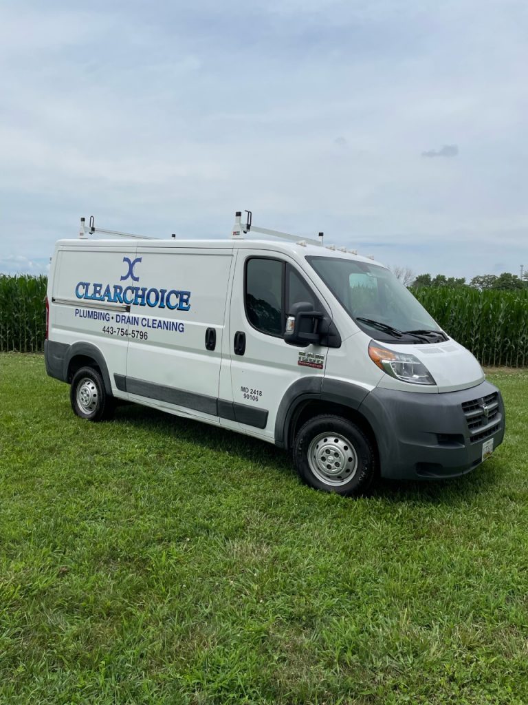 The ClearChoice Plumbing, LLC van, parked out on a grassy field