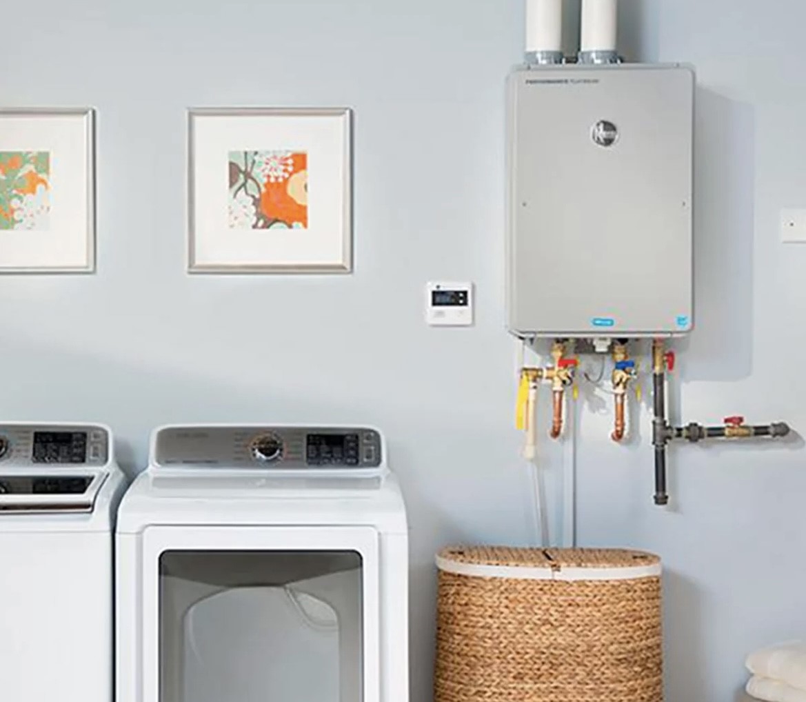 A tankless Rheem water heater in a laundry room