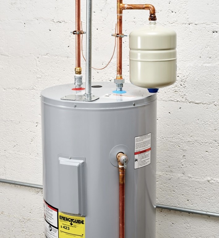 Water heater against a white concrete wall